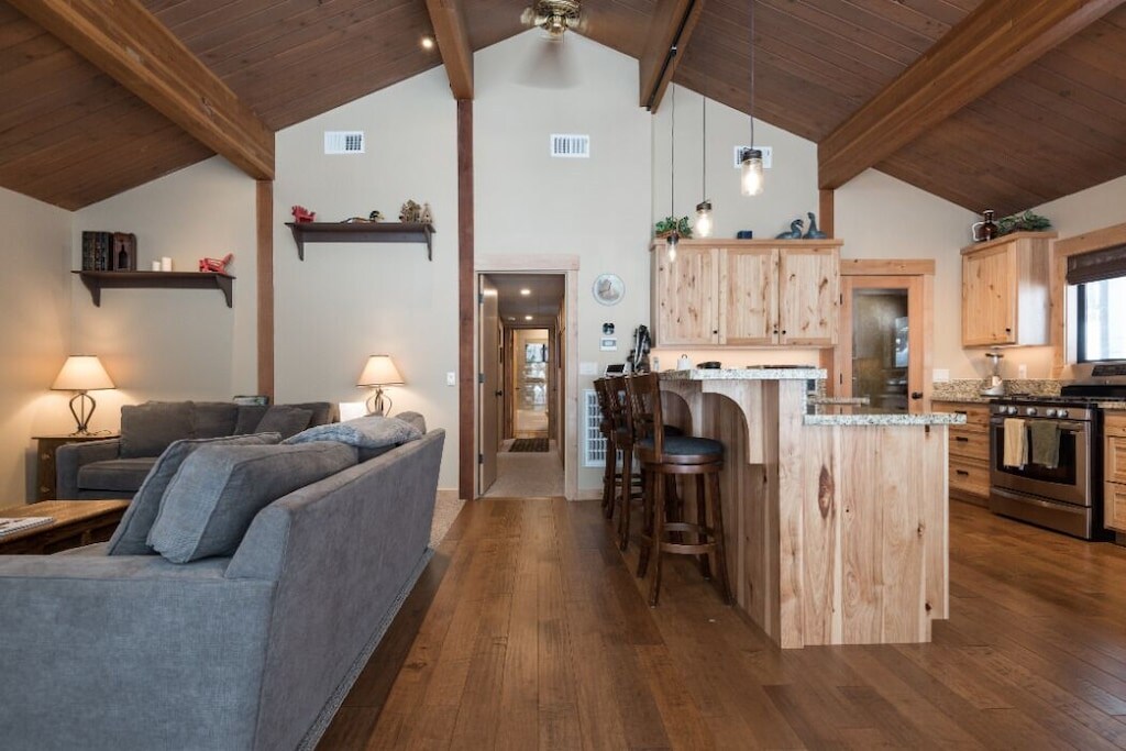 Open-concept kitchen and living area with breakfast bar seating.