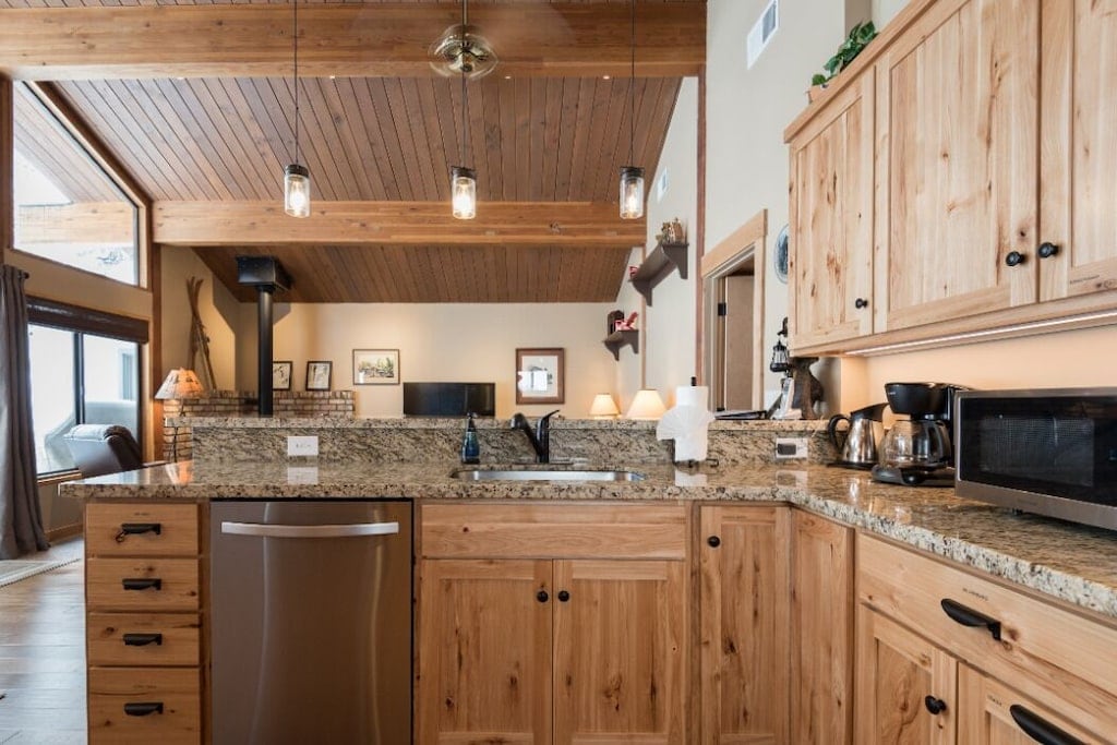 Kitchen with granite counters, dishwasher, and generous cabinet storage.