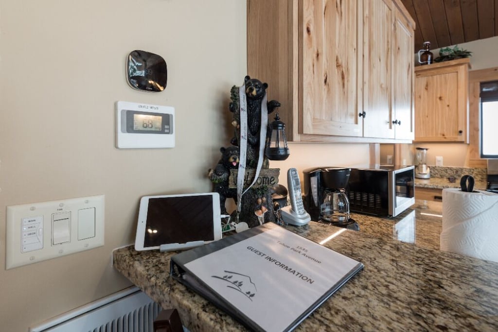 Kitchen counter with guest guidebook and convenient trip-planning details.