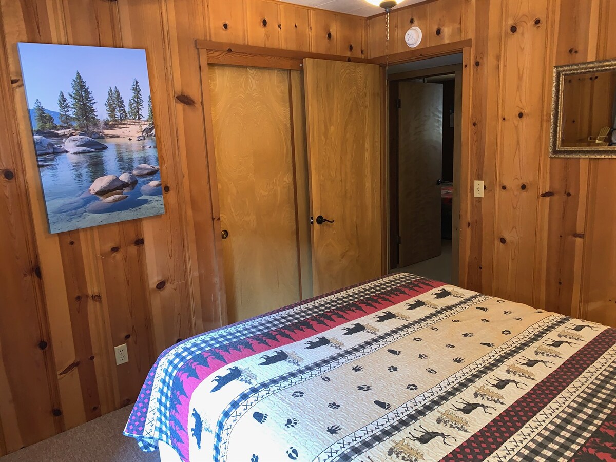 Middle bedroom with queen bed and closet storage.