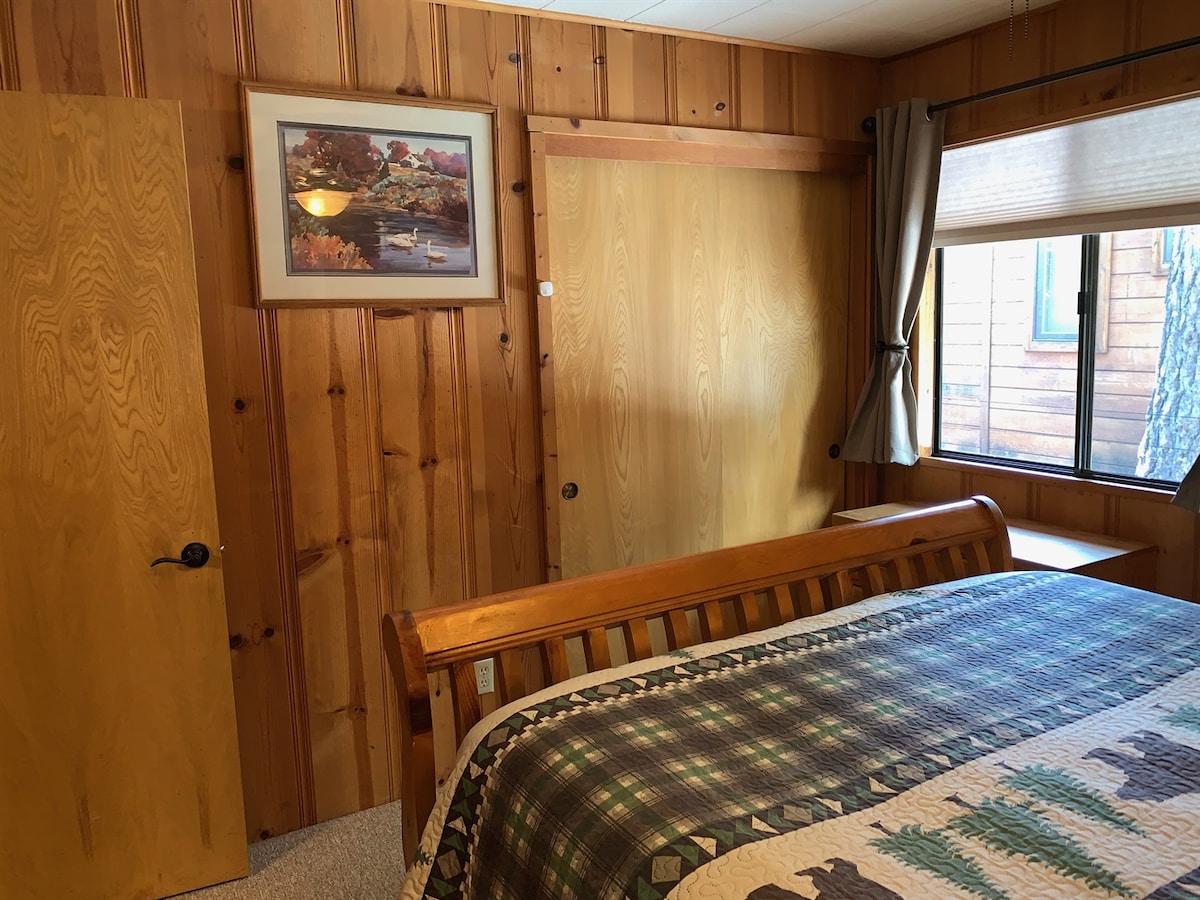 Back bedroom with queen bed and closet storage.
