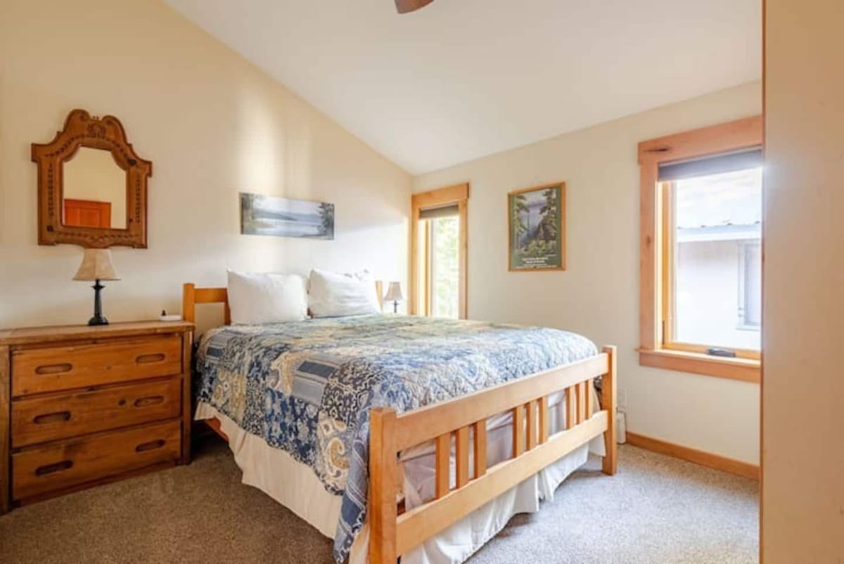 Middle bedroom with queen bed and dresser.