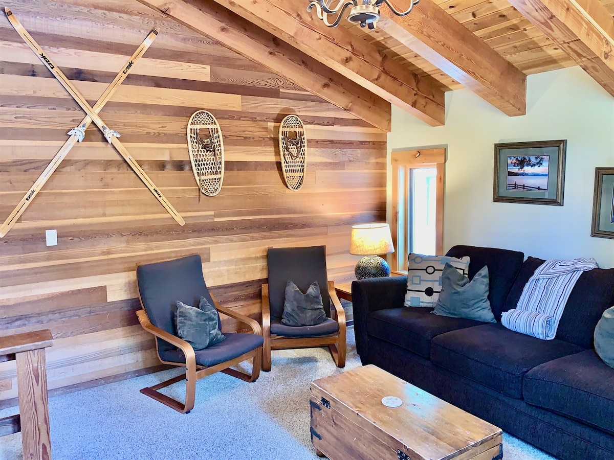 Living room seating with Tahoe-style wood accent wall.