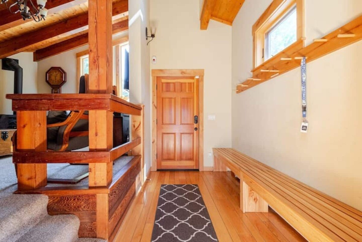 Entryway with bench, staircase, and warm wood details.