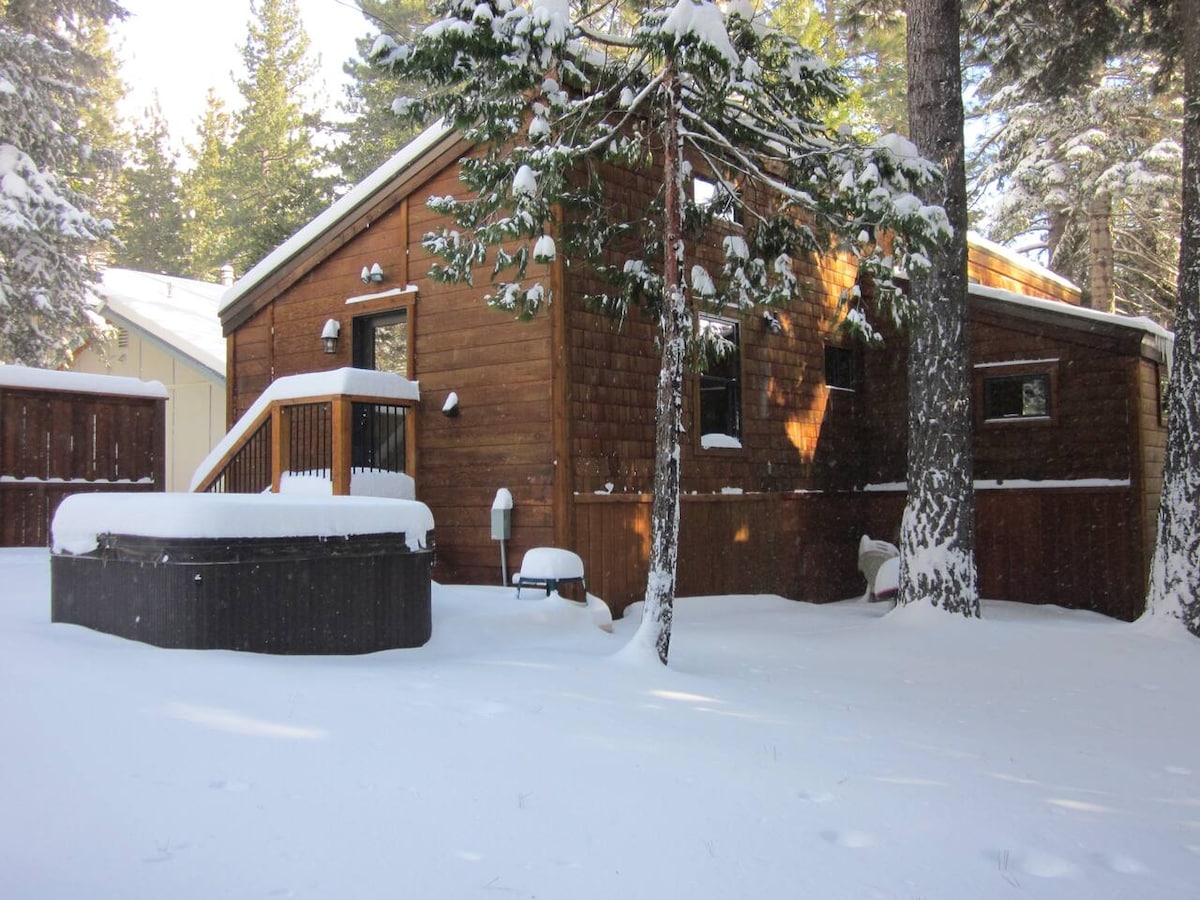 Backyard hot tub and house exterior in winter.
